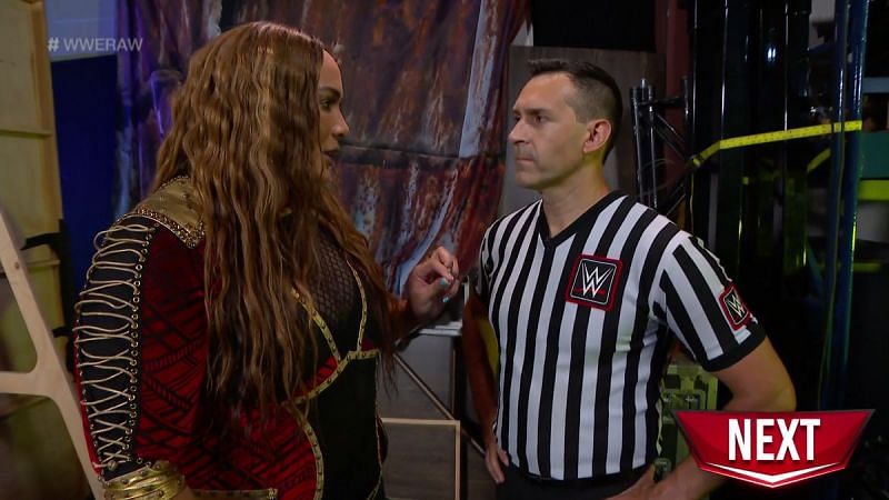 Referee John Cone and Nia Jax.
